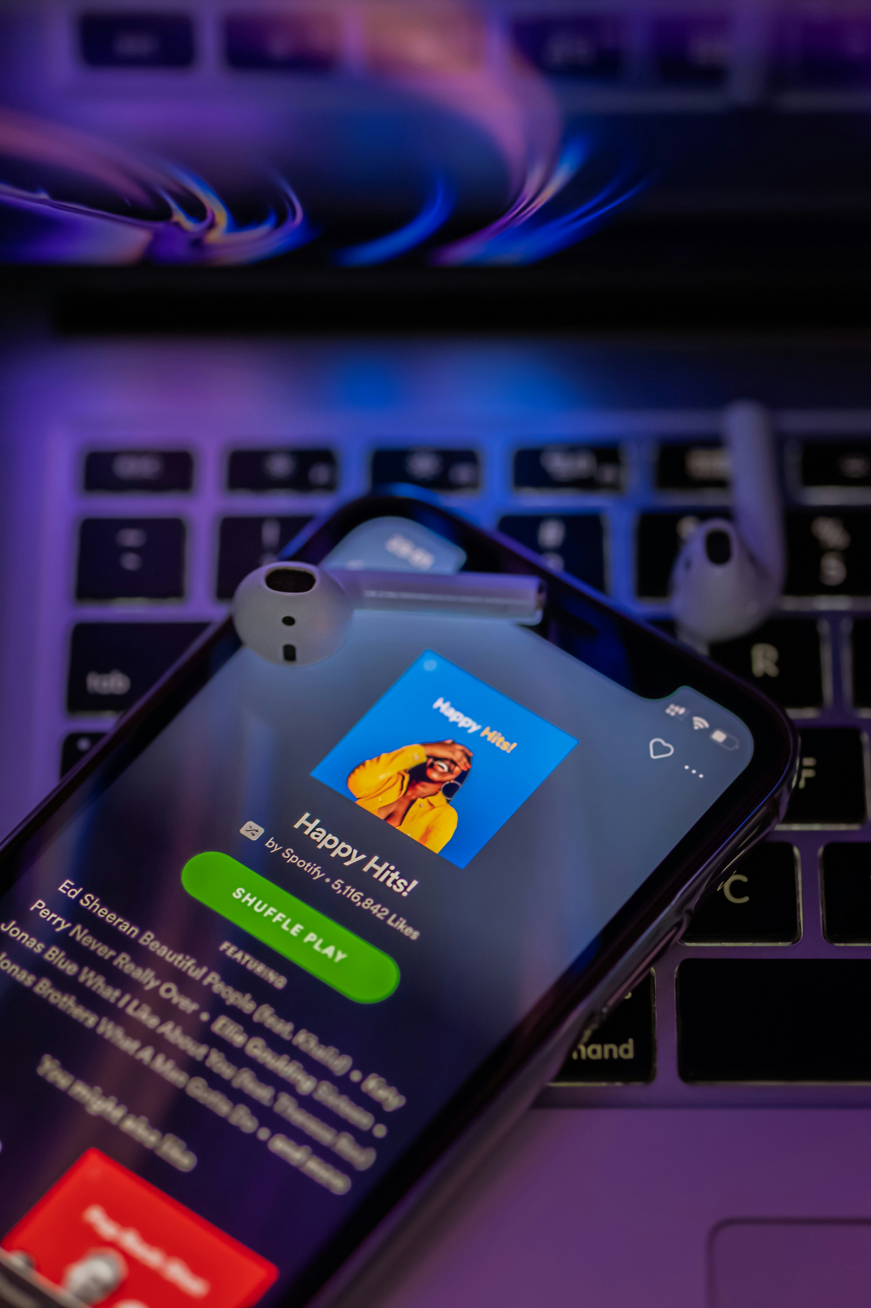image of happy hits spotify playlist on phone