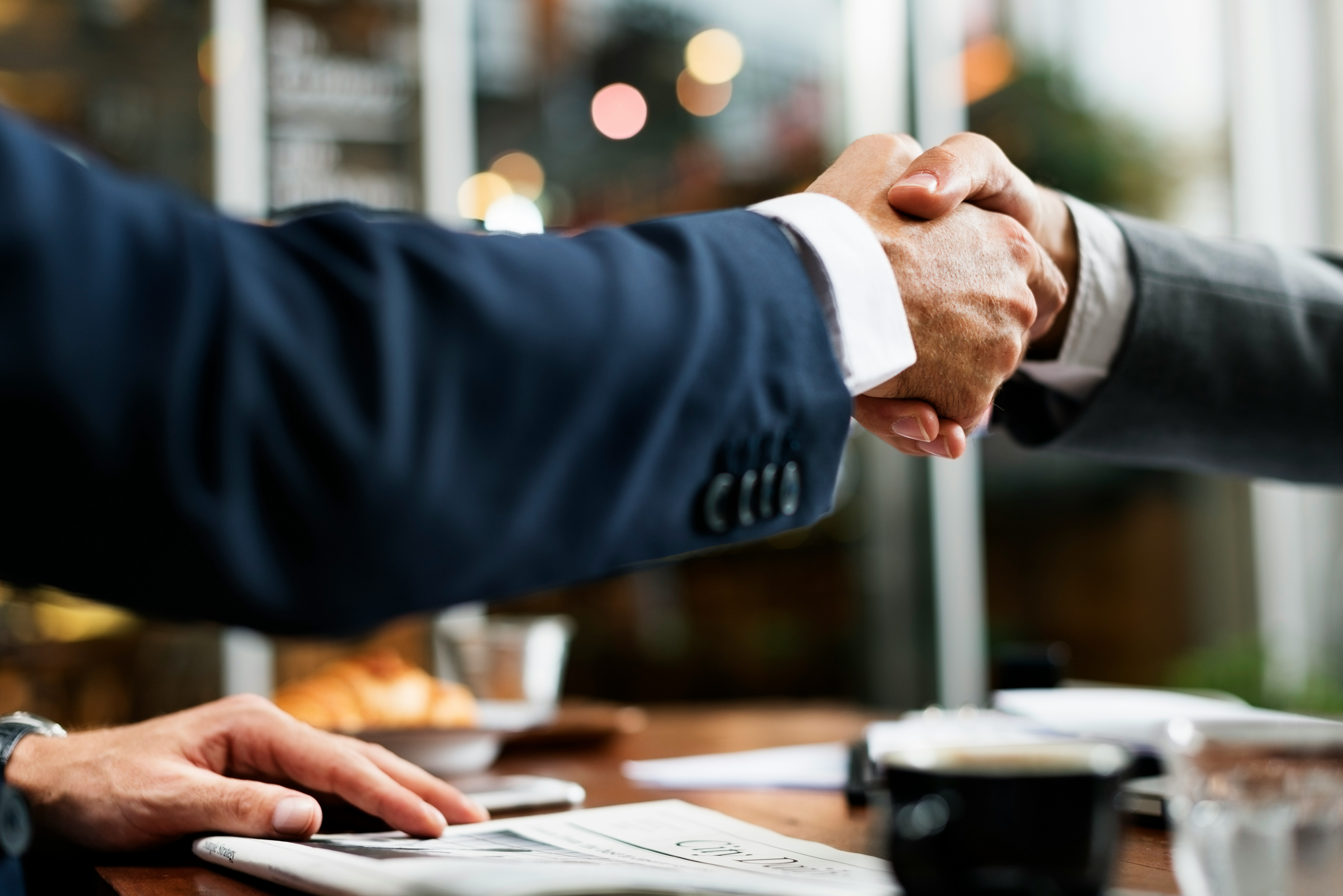 two people shaking hands in agreement